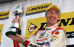 Matt Neal lifts the BTCC Drivers Championship trophy